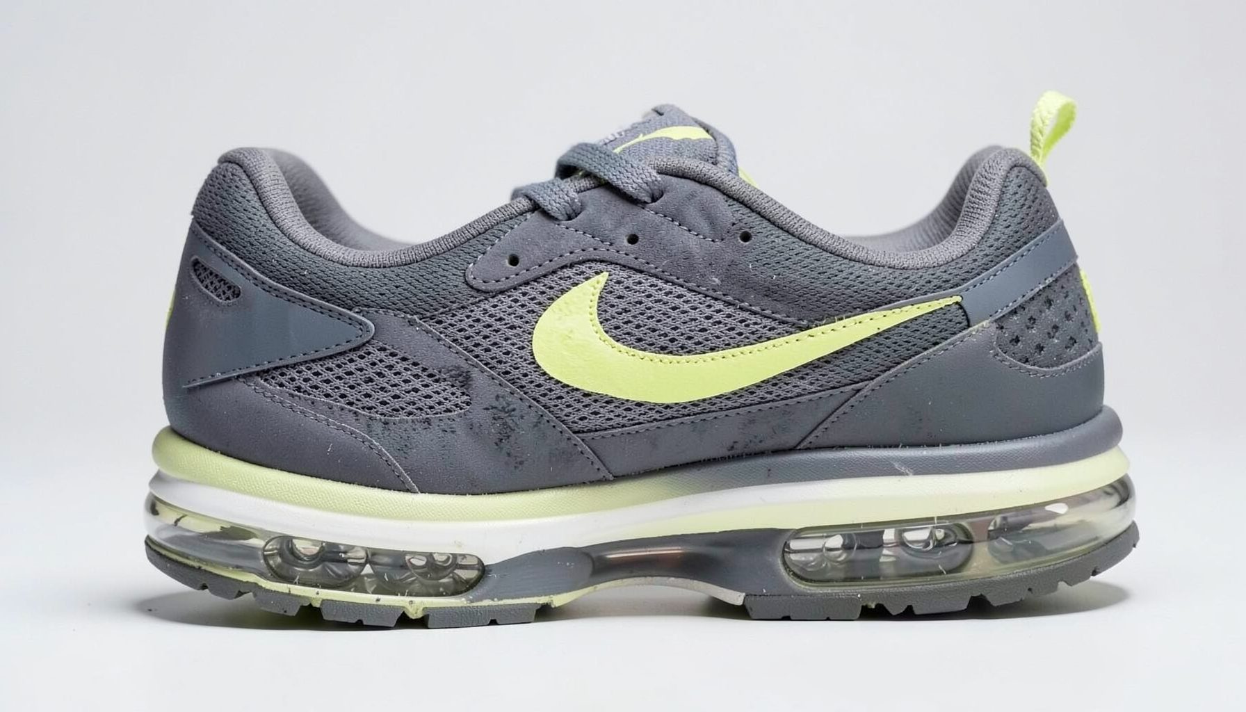 Nike Air Max 2011 running shoe with visible air cushioning, dark gray and volt green