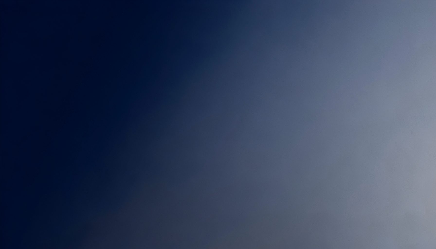 Soft gradient of deep navy blue fading into muted steel gray, with a calm and professional atmosphere