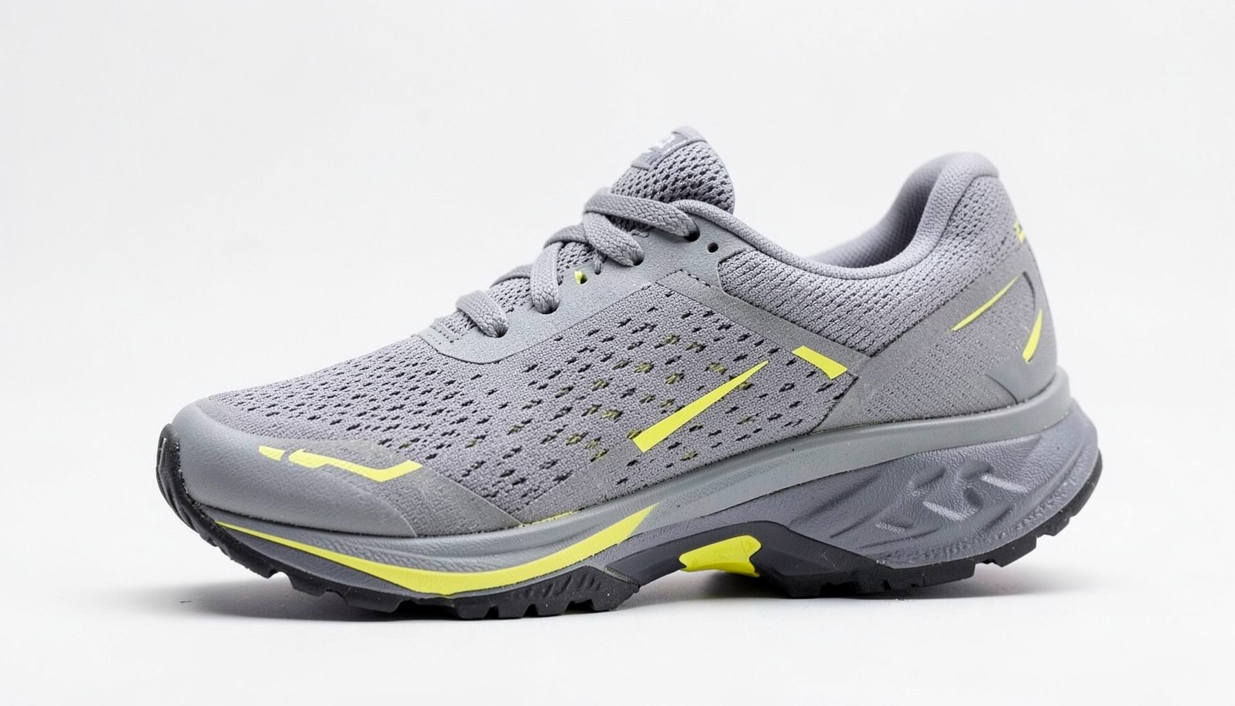 Women's running shoe in gray with yellow highlights and a dark outsole