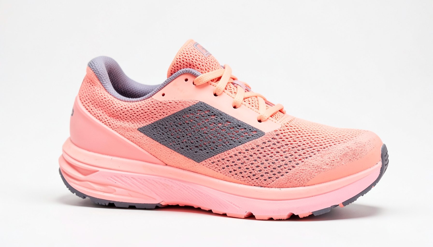 Women's running shoe in peachblow pink with dark gray mesh panels